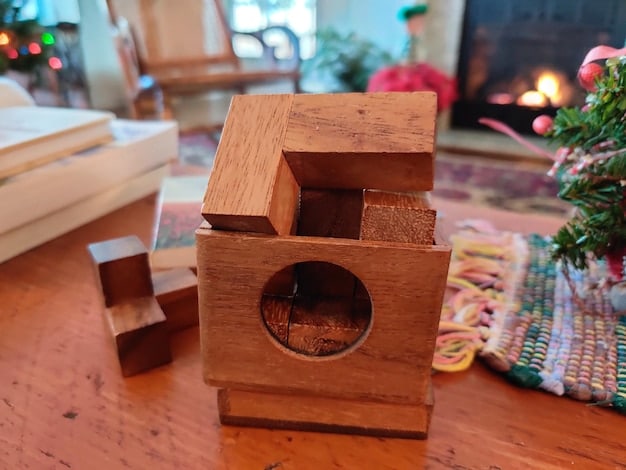 A detailed shot showcasing various budget-friendly materials for a DIY cat tree, including reclaimed wood planks, sisal rope spools, carpet remnants, and a selection of hand tools neatly arranged on a workbench.