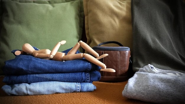 A close-up shot of various piles of neatly folded old clothing, including t-shirts, sweaters, and jeans. A measuring tape and a pair of scissors are placed on top of one of the piles.