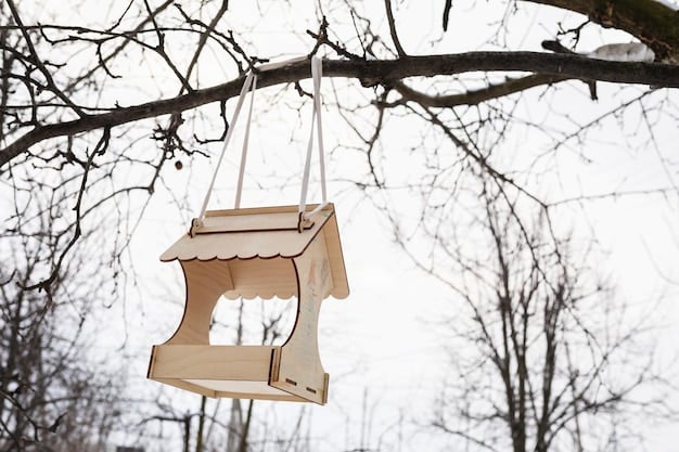 A medium shot of a simple platform bird feeder made from a repurposed wooden pallet, filled with sunflower seeds and mounted on a sturdy pole in a suburban US backyard. Several sparrows and finches are feeding on the seeds.