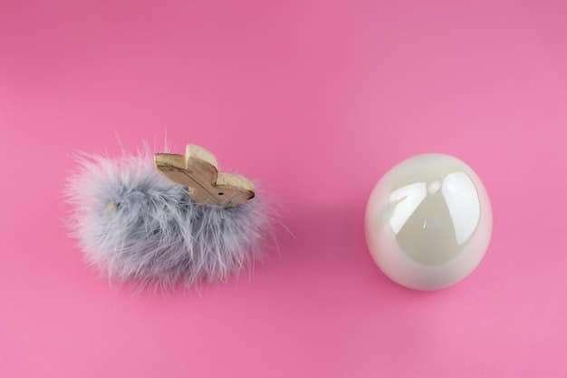 A close-up shot of a completed catnip mouse toy, made of grey felt with pink ears and a long, thin tail. The toy is lying on a wooden surface, and the background is slightly blurred, emphasizing the details of the toy and its handcrafted quality.