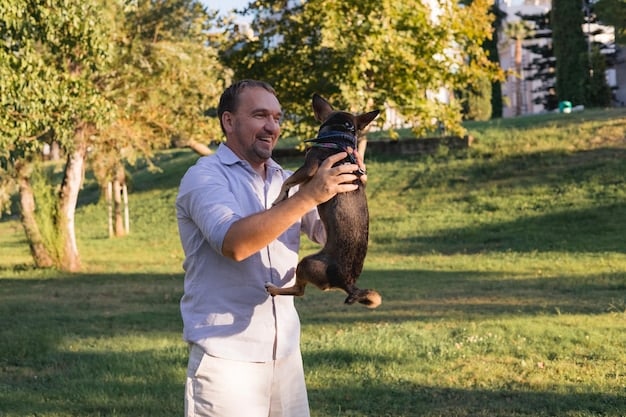 A dog trainer smiling and offering a treat to a calm German Shepherd during a desensitization session. Simulated firework sounds are playing softly in the background.