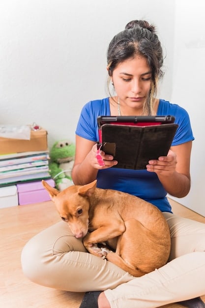A veterinary technician holding a chart detailing a pet's vaccination schedule while petting a calico cat on the examination table. The cat looks relaxed and comfortable.