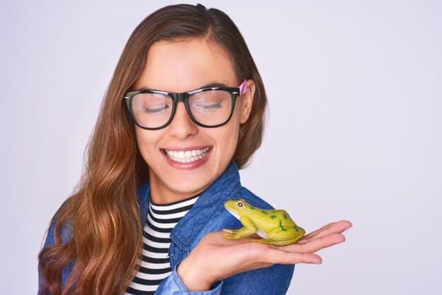 A photograph of a young woman holding a small, brightly colored gecko in her hand, smiling. The setting is a modern apartment, emphasizing the pet's integration into urban living.