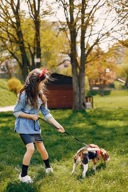 A playful scene of a child laughing while playing fetch with their dog in a sunny park. Both are clearly enjoying the activity.